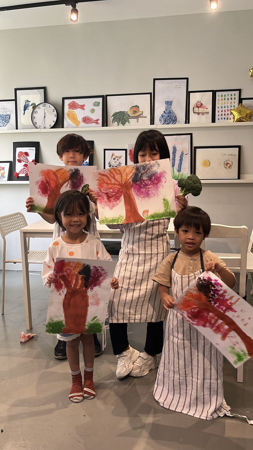 Students at Master Artist showing their finished paintings