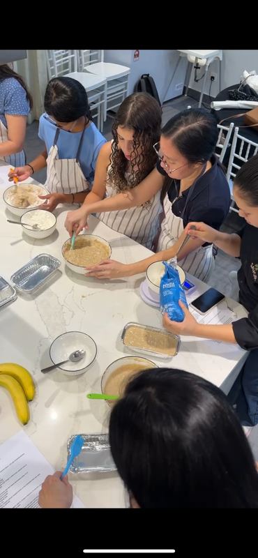 Students mixing batter at a baking workshop