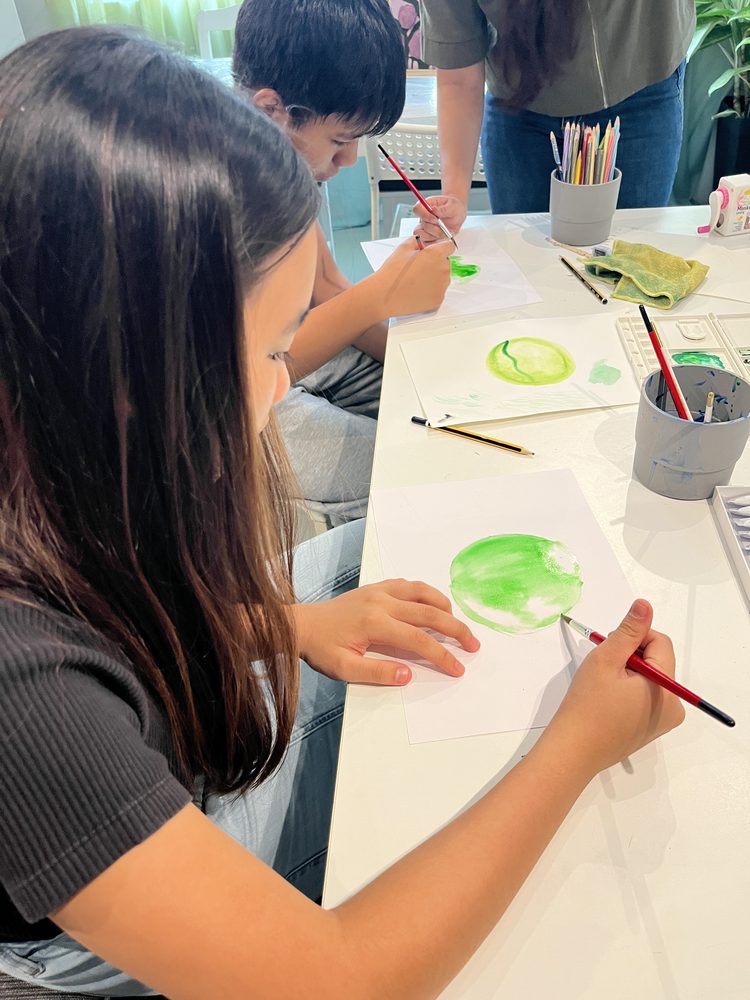 Students painting watercolour circles together