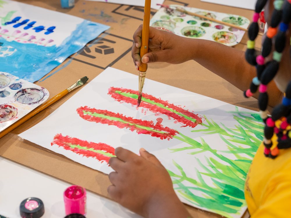 Close-up of a student painting a watercolour design